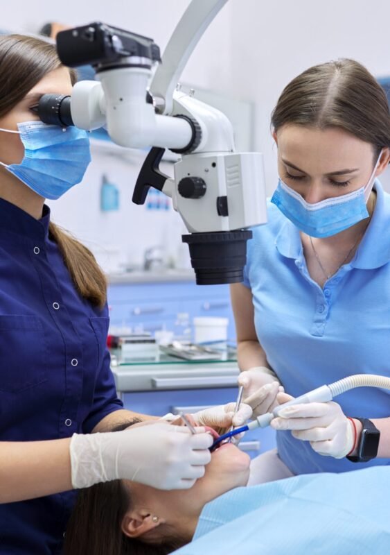 Healthcare dentistry medicine, woman doctor dentist treats teeth using dental microscope and tools. Professional modern dental equipment