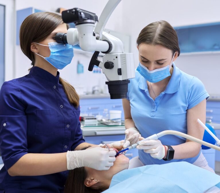 Healthcare dentistry medicine, woman doctor dentist treats teeth using dental microscope and tools. Professional modern dental equipment