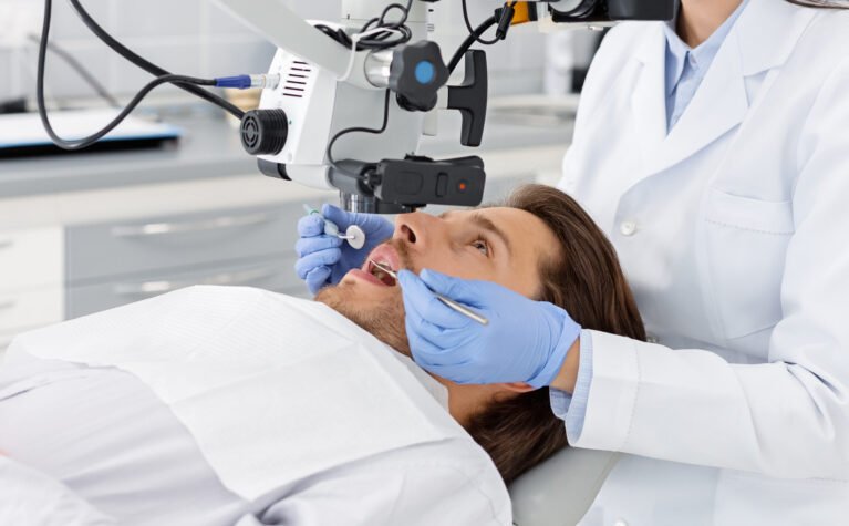 Male patient having professional dental treatment in modern cabinet, cropped