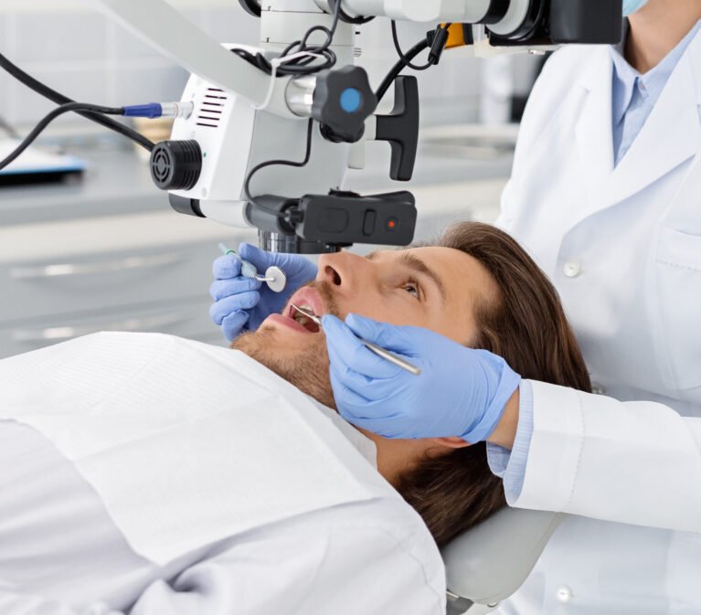 Male patient having professional dental treatment in modern cabinet, cropped